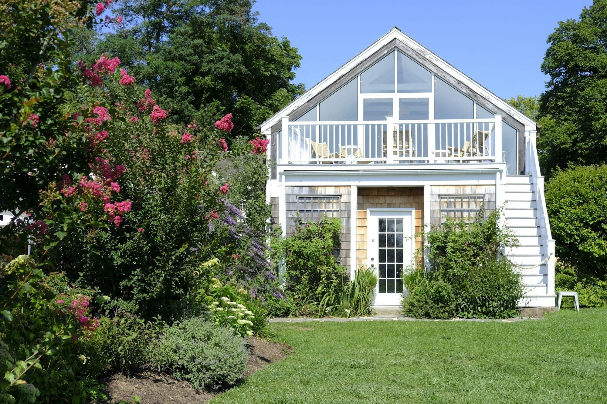 Cedar-shingle cottage with an upper deck and garden