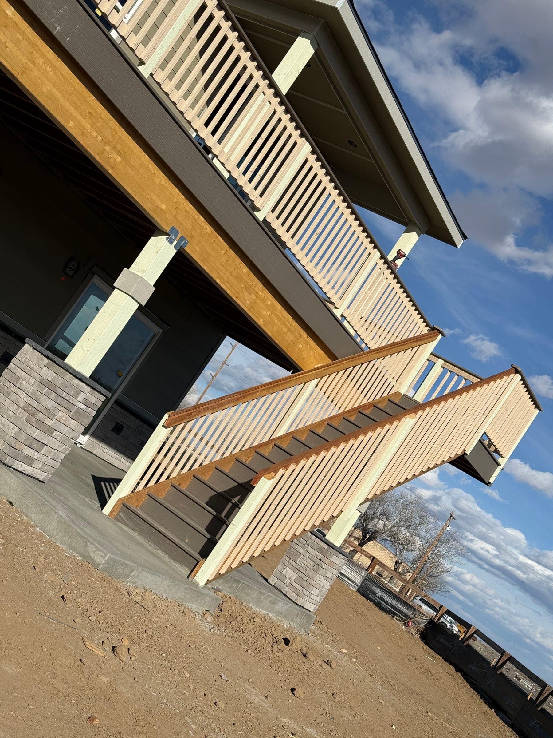 Custom exterior staircase and railing, looking up from below