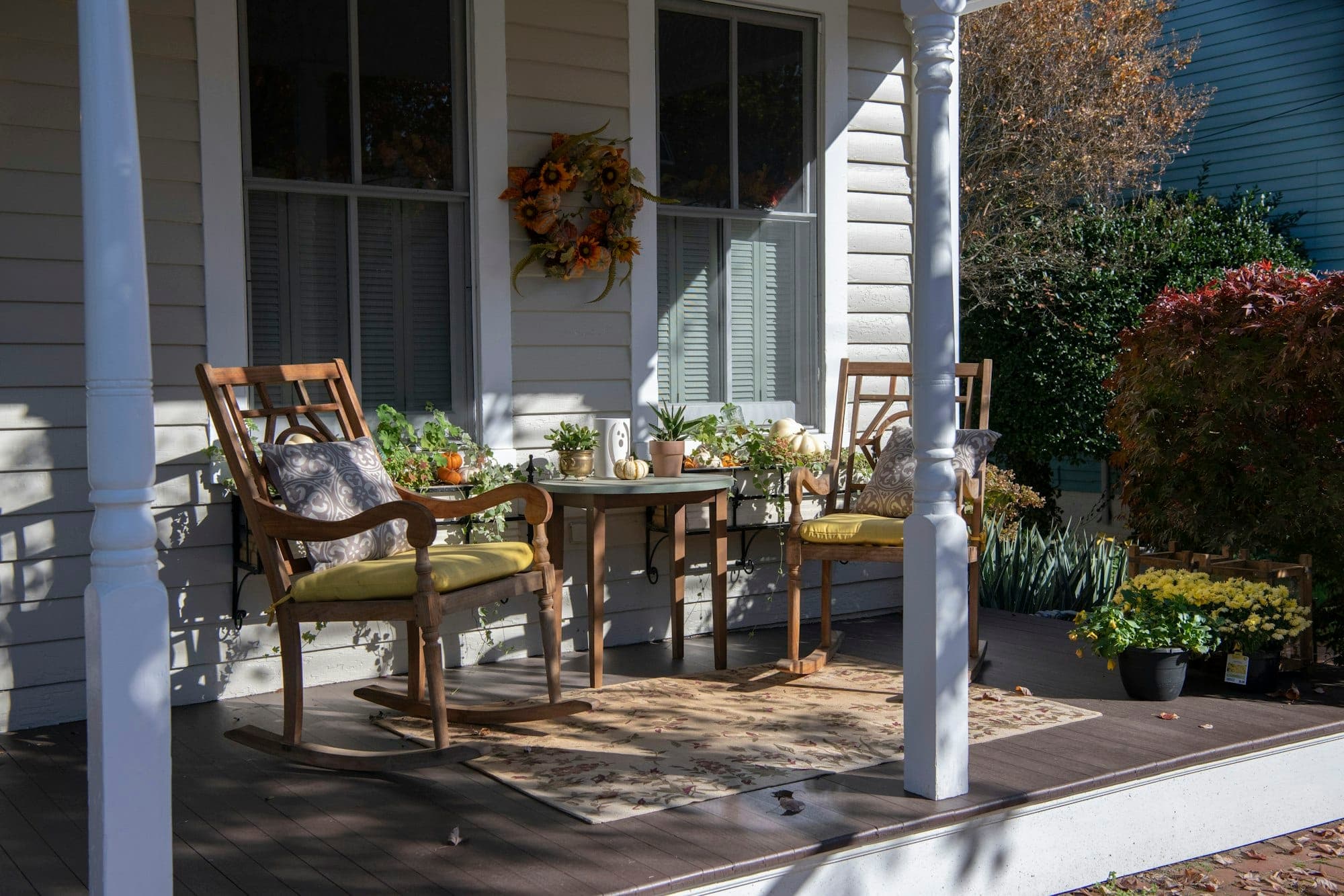 Covered porch with rocking chairs in autumn light