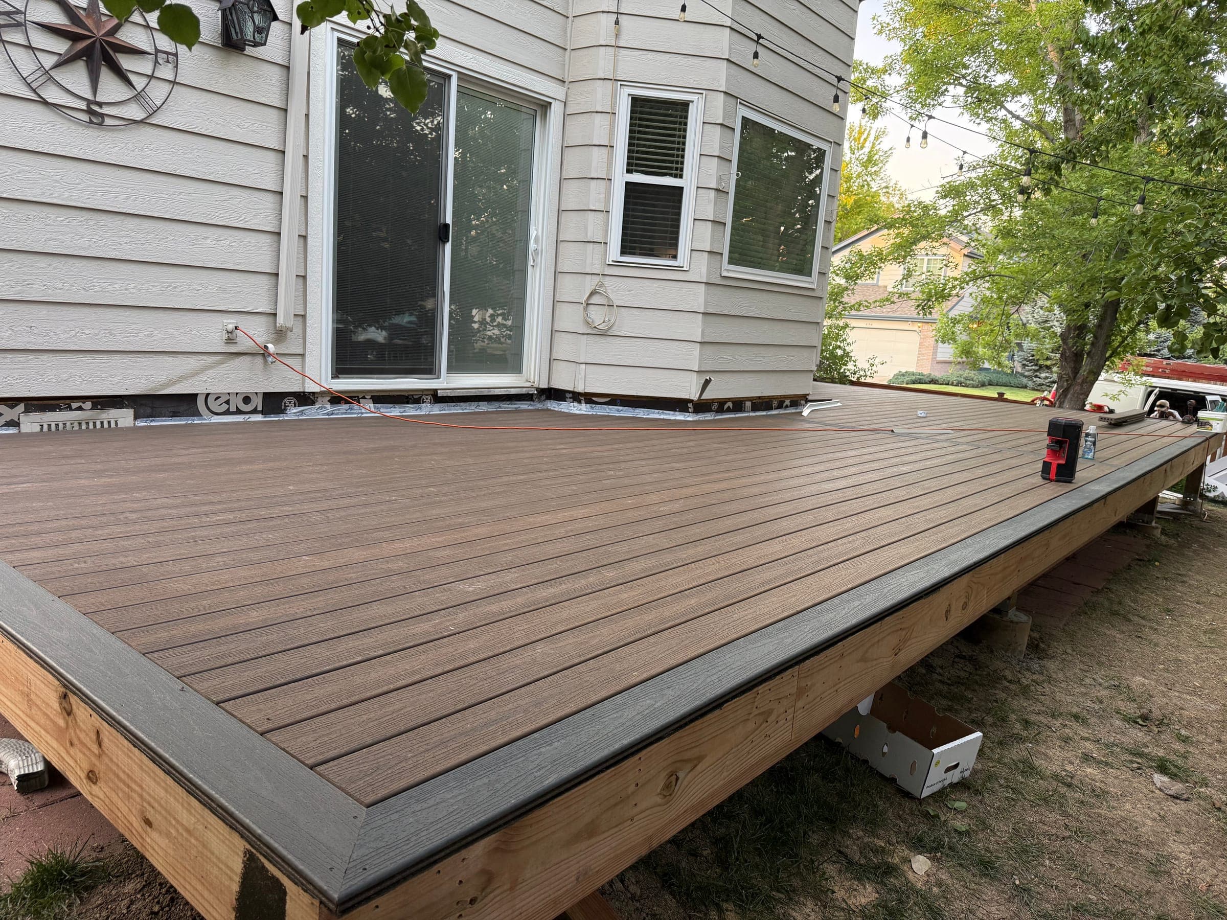 Freshly laid two-tone composite deck by Skyview Construction, evening light