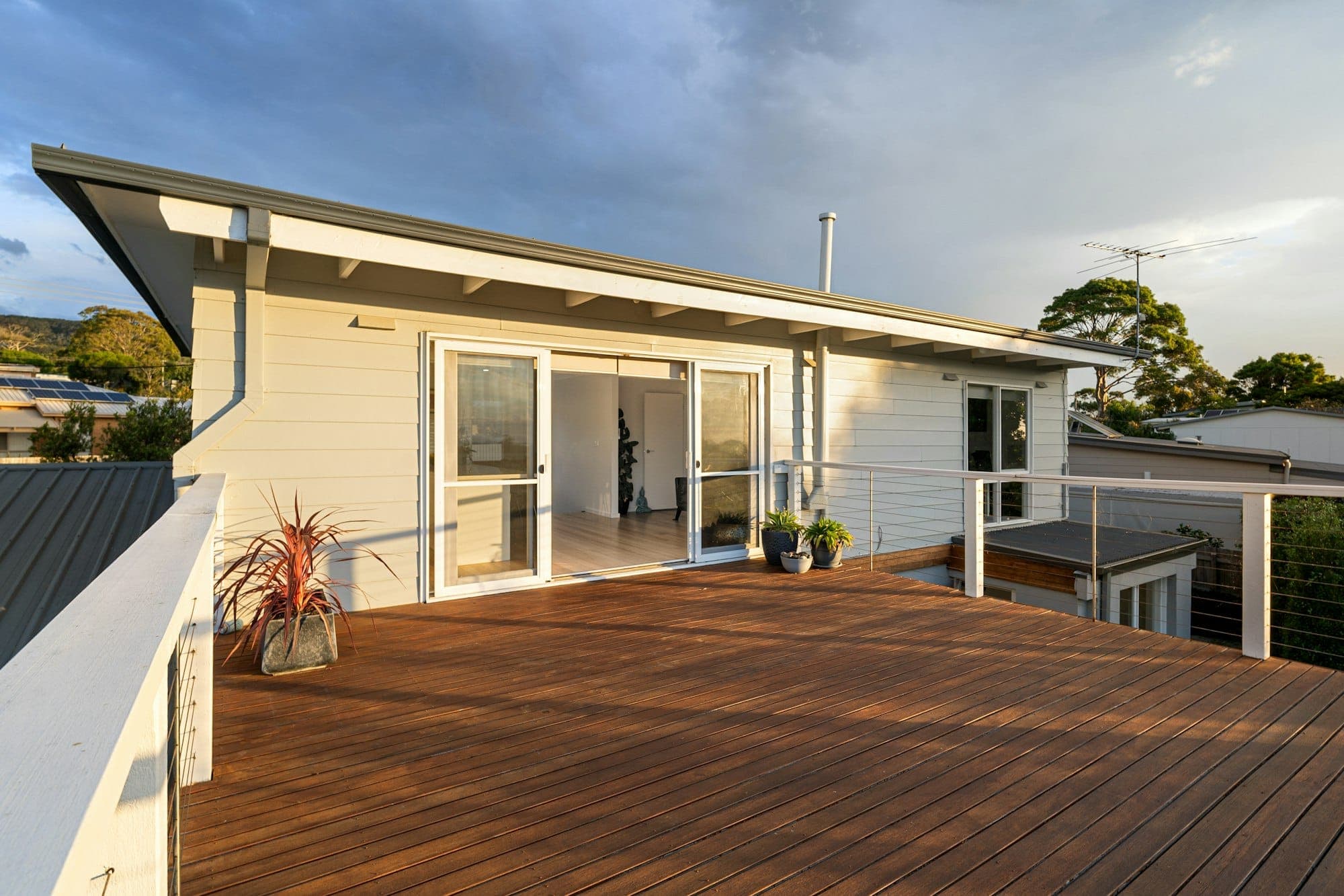 Timber deck with cable railing in golden-hour light